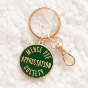 Gold and green keyring on a white background